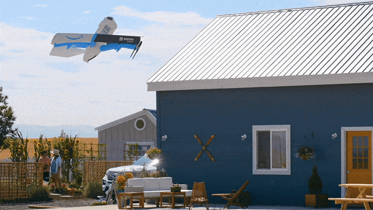 An animated GIF of an Amazon delivery drone dropping a parcel outside a house.