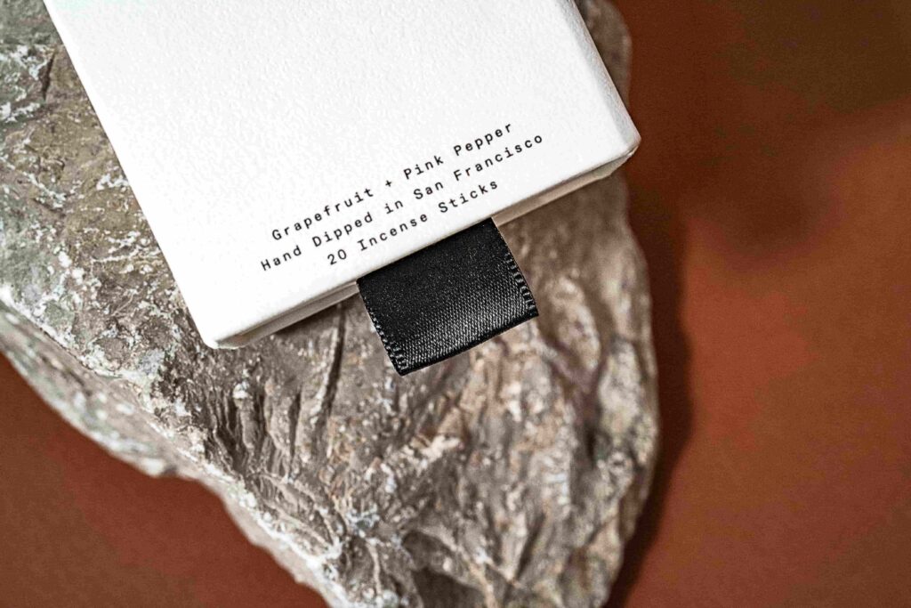 Close-up shot of ribbon pull tab of the incense sticks packaging.