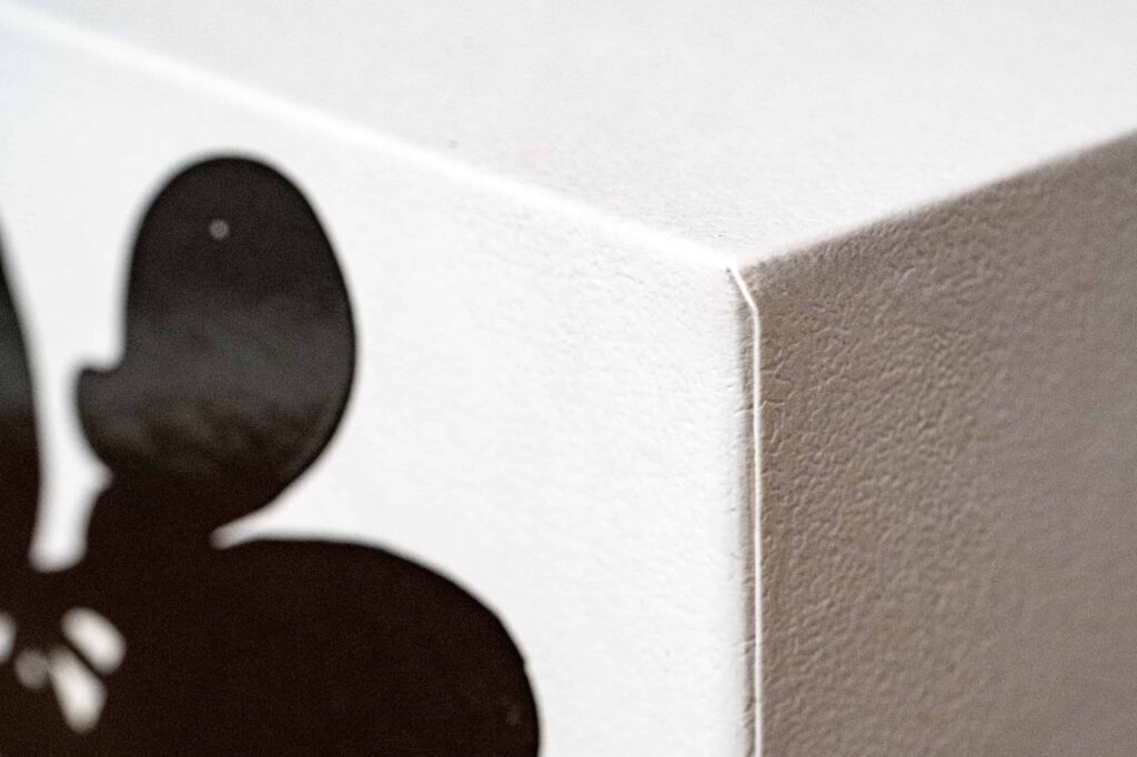 Close-up shot of candle box showing the paper texture and the crisp corner.