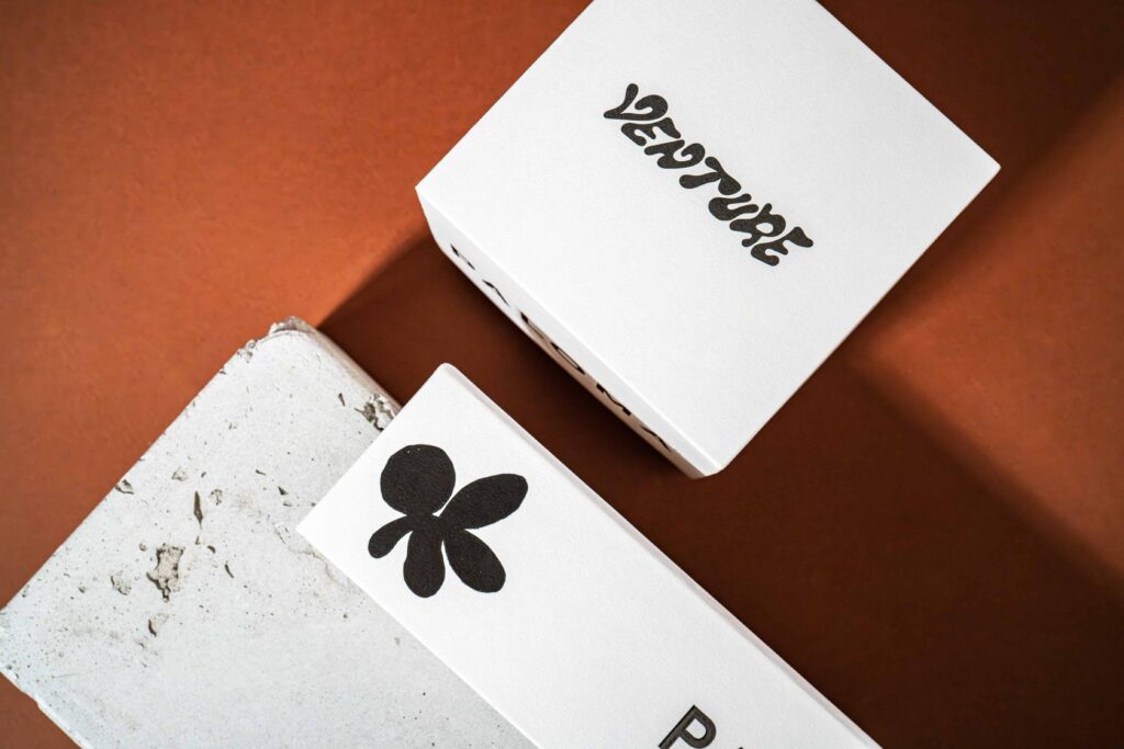 Boxes showing Venture's brand name and botanical artwork.