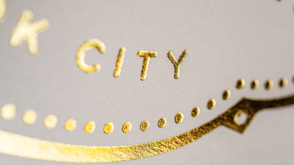 close-up of the gold foil stamping of Via Carota's logo