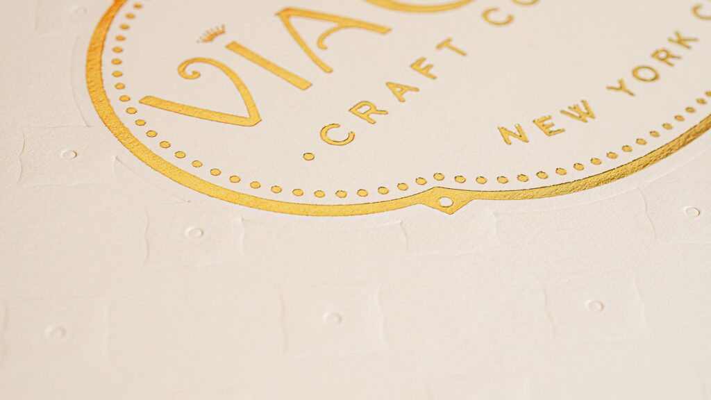 close-up of the embossed branded pattern with foil stamped logo